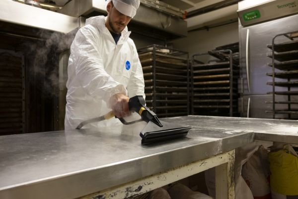 Steam cleaning counter tops in a restaurant/bakery